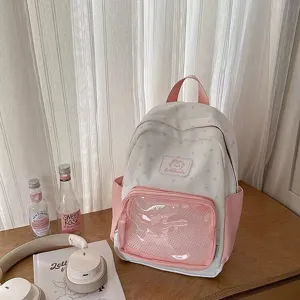 Detail view of the cute pink and white star print canvas ita backpack with clear front pocket.