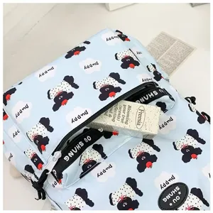 Light blue cartoon puppy print backpack, casual school bag with zipper pocket and cute style.