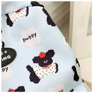 Detailed close-up of the cute cartoon puppy printed blue backpack fabric showing clear patterns.