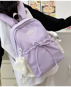 Korean style minimalist large capacity purple canvas backpack with cute front bow detail.