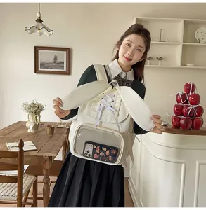 Sweet bunny ear backpack with ribbon lace-up design and transparent ita bag pocket for daily use.
