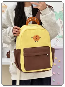 Zaino in tela carino con ricamo di biscotti di cartoni animati, elegante borsa scolare per studenti.