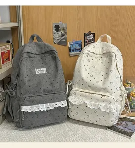 Detailed view of the cute corduroy floral backpack with sweet lace trim and front pocket design.