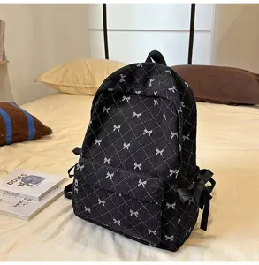 Black corduroy backpack for women, cute bow pattern school bag, large capacity casual daypack.