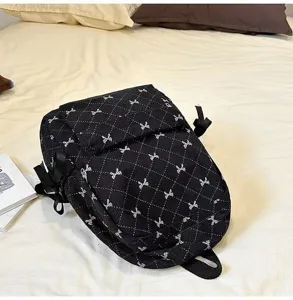 Stylish black quilted backpack with cute bow embroidery for women and students daily use.