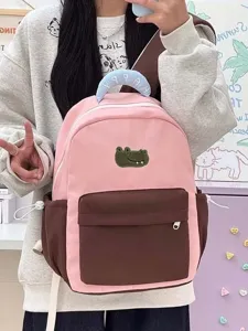 Pink and brown canvas student backpack with cute cartoon crocodile patch and spacious design.