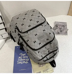 Grey bow backpack detail showing durable fabric texture and cute black bows for daily student use.