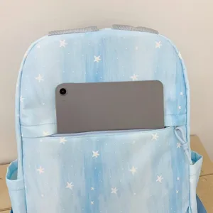 Detail view of the light blue star print backpack showcasing its spacious front tablet pocket storage.