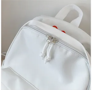 Detail shot of a white casual backpack featuring metal zippers and cute flower embroidery.