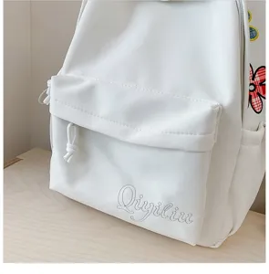 White casual canvas backpack for women, large capacity student school bag with embroidery.