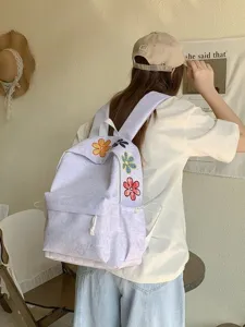 Casual canvas backpack with cute colorful flower embroidery, large capacity student school bag.