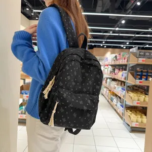 Sweet bow corduroy backpack for women, large capacity casual student school bag style.