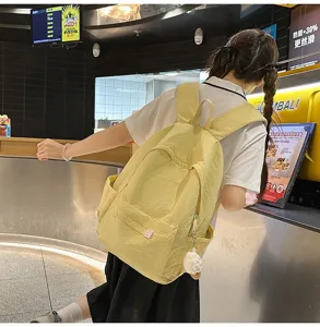 Japanese style solid color backpack for women, casual student school bag with large capacity.