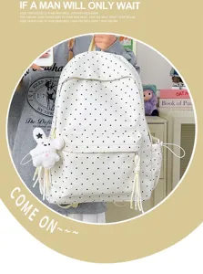 Detail view of the cute polka dot backpack with plush bunny pendant and side drawstrings.