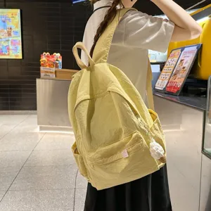 Casual yellow nylon backpack for women, minimalist large capacity student school bag.