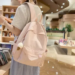 Casual pink canvas backpack for women, large capacity minimalist school bag for daily commute.