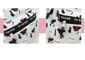Detailed view of the cute cartoon puppy print backpack, showing zipper and fabric details.