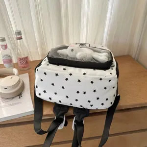 White star print ita backpack with transparent front pocket and cute plush toy detail.