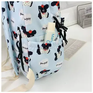 Detailed view of the cute cartoon puppy print backpack side pocket, student school bag.