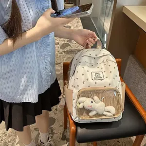 Korean style star print backpack with transparent front pocket and cute plush toy for girls.