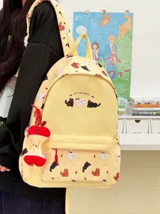 Cute cartoon cat print canvas backpack, stylish casual school bag for women and student daily use.