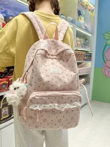 Pink corduroy backpack with sweet floral print, lace ruffle trim and cute plush pendant for women.