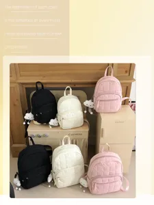 Detailed view of casual quilted mini backpack with cute cloud charm in multiple colors.