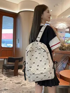 Fashionable corduroy backpack with bow pattern, large capacity school bag for women commute.