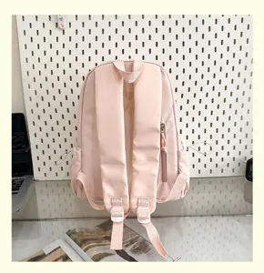 Cute pink casual backpack for women, large capacity student school bag, stylish daily travel daypack.