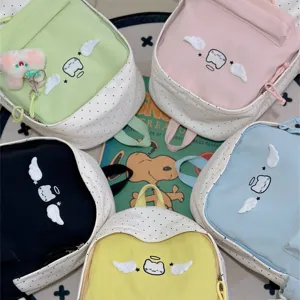 Sac à dos mignon chat ange dessin animé avec motif à pois doux, cartable scolaire décontracté coloré.