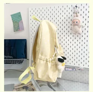 Yellow polka dot backpack for women, cute casual school bag with large capacity daily use.