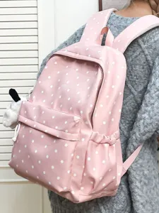 Pink polka dot backpack for women, cute Korean style school bag with large capacity and cute pendant.
