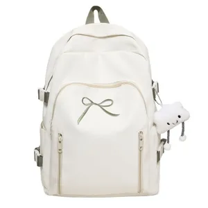 White sweet bow backpack with green embroidery and cute cloud pendant for school daily use.
