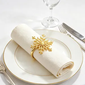 Gold snowflake napkin ring for Christmas table decor, elegant metal napkin holder.