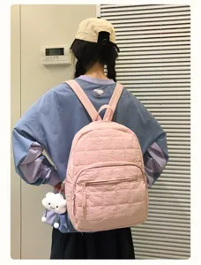 Detail view of the pink quilted casual backpack, featuring a cute cloud pendant and large capacity.