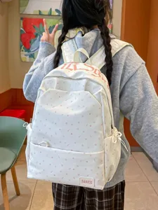 Korean ins fashion polka dot backpack for women, large capacity student casual school bag.