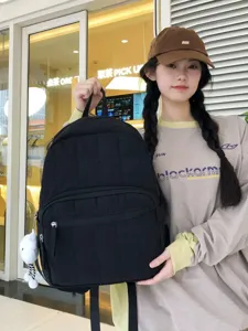 Korean style minimalist solid black quilted backpack with large capacity and cute pendant for women