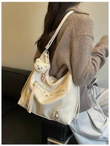 Fashionable women shoulder bag with metal studs and cute bear pendant, large capacity.