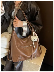 Stylish brown PU leather hobo shoulder bag with cool motorcycle style, studs and cute bear pendant.