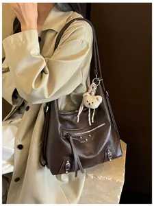 Classic dark brown leather shoulder bag with chic motorcycle style studs and handy pockets.
