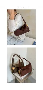Elegant retro suede shoulder bag with floral charm, stylish casual everyday tote for women.