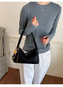 Black suede shoulder bag for women, retro casual underarm handbag with cute flower charm.