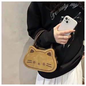 Cute cat shaped handbag detail shot showing the unique ear design, handle, and texture.