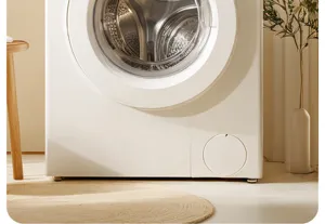 Modern white front load washing machine in a cozy home interior setting close up view.