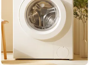 Close-up view of a modern white front load washing machine in a cozy home interior setting.