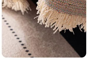 Close up of colorful woven sofa blanket tassel detail, premium textured decorative throw cover.