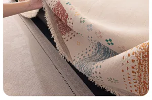 Detailed close-up showing the soft textured woven fabric and delicate fringes of the sofa cover.