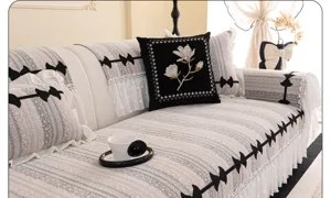 Chenille sofa cover detailed view showing elegant lace trim and black embroidered pillow design.