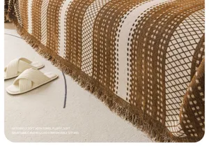Detailed view of cozy brown checkered chenille sofa towel blanket with nice fringe edge