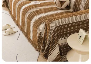 One-piece chenille sofa cover with brown and white grid pattern and tassels for home decor.